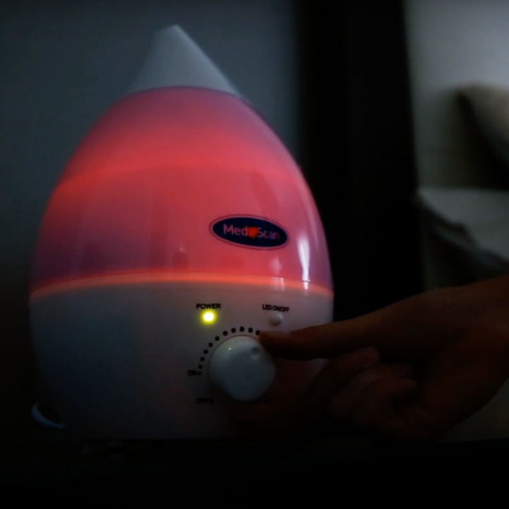 Rainbow Mist Ultrasonic Cool Mist Humidifier in action in the dark