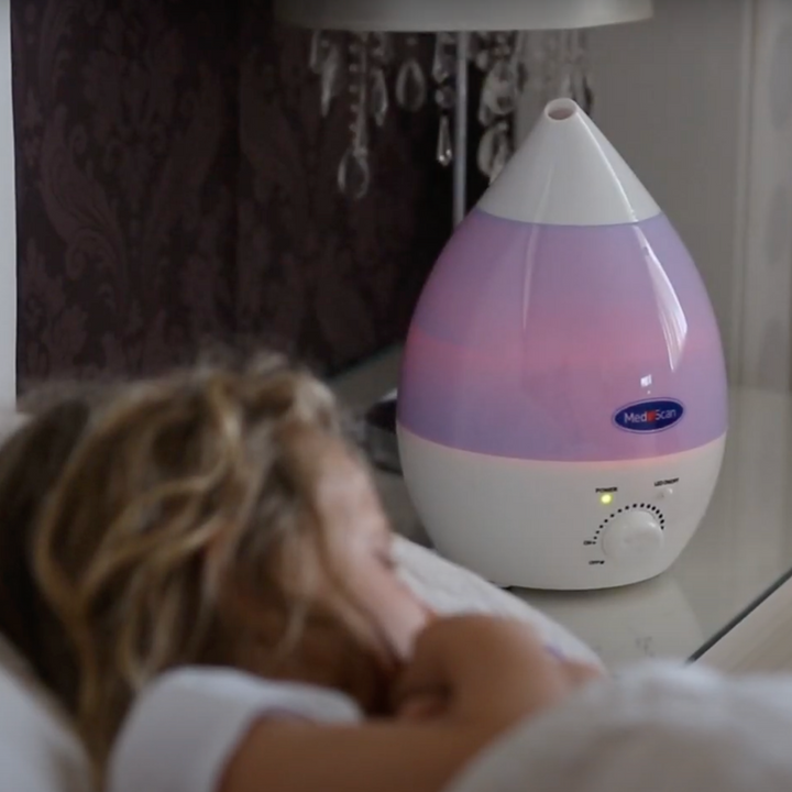 Rainbow Mist Ultrasonic Cool Mist Humidifier in action next to a girl sleeping